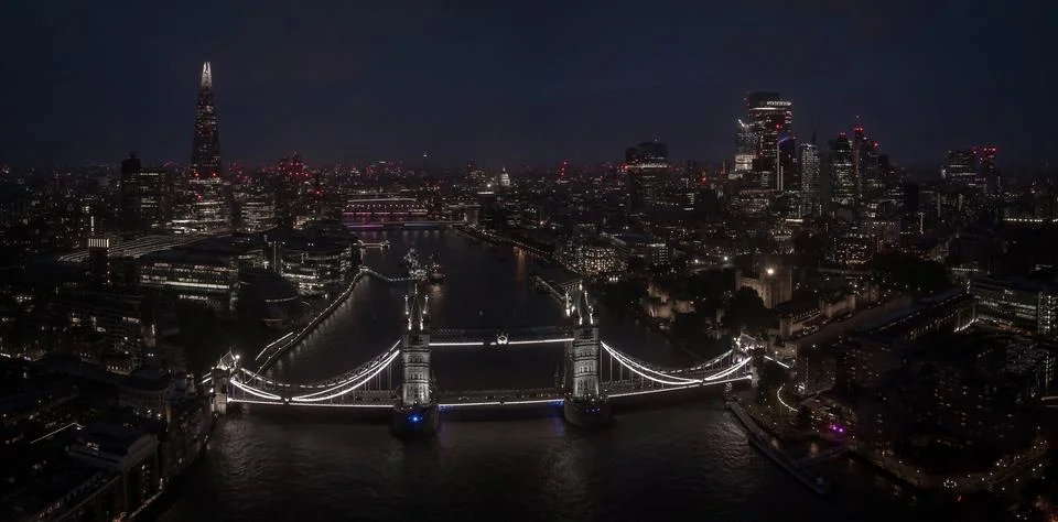 Aerial view to the illuminated Tower Bridge and skyline of London, UK Stock Photos