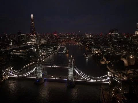 Aerial view to the illuminated Tower Bridge and skyline of London, UK Stock Photos