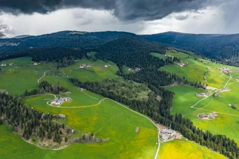 Aerial view of improbable green meadows of Italian Alps, green slopes of the Stock Photos