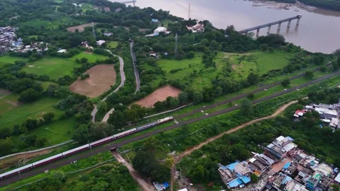 Aerial View of an Indian Train Crossing a River Bridge Видео 341548110