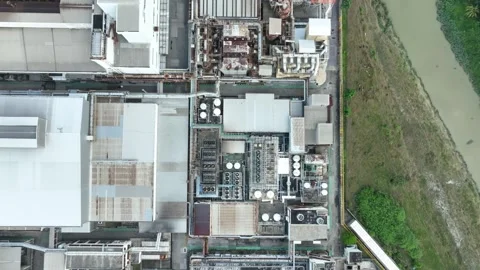 Aerial view of industrial complex and surrounding green land during daytime Stock Footage 312913386
