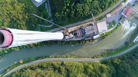 Aerial view of industrial complex and chimney beside river Stock Footage 325671341