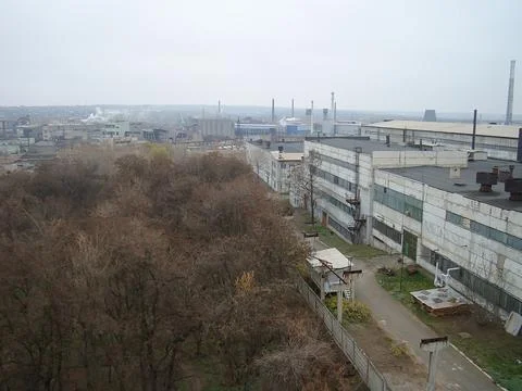 An aerial view of an industrial complex with multiple buildings, located in a Stock Photos