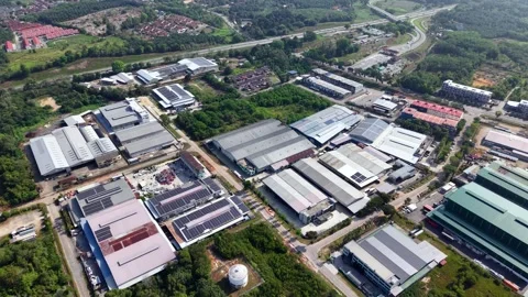 Aerial view of industrial complex nestled in green surroundings Видео 333041054