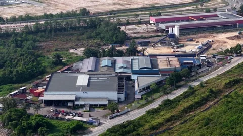Aerial view of industrial complex surrounded by greenery Stock Footage 333586713