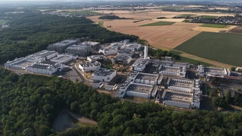 Aerial view of industrial complex surrounded by forest and fields Stock-Footage 343096850