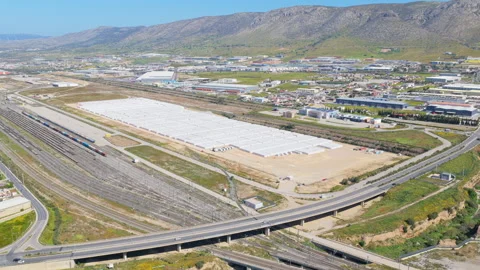 Aerial view of a industrial facility featuring a large logistics center with Stock Footage 334667536