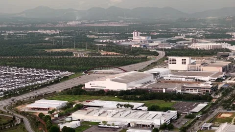 Aerial view of industrial factory complex with roads and distant mountains Stock Footage 336947875