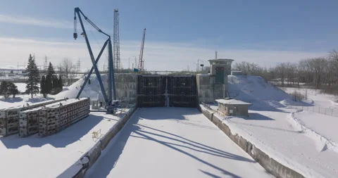 Aerial View of an Industrial Lock System Under Maintenance in a Snowy Landscape Stock Footage 301579948