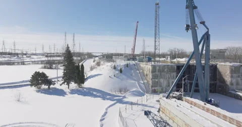 Aerial View of an Industrial Lock System Under Maintenance in a Snowy Landscape Stock Footage 301579983