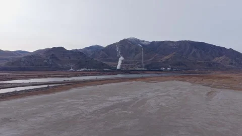 Aerial view of industrial smelter stack near Great Salt Lake in Magna, Utah Stock Footage 333879768