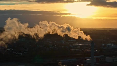 Aerial view of industrial smoke stack at sunset in Latvia. 動画素材 340590592