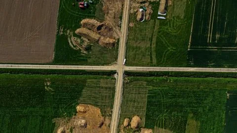 Aerial View of Infrastructure Construction Trench Crossing Agricultural Fields Fotos de archivo