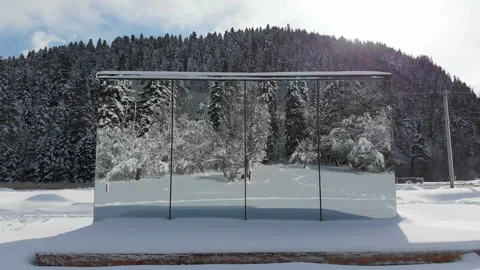 Aerial view of an innovative high-tech house with mirrored walls amid a winter Stock Footage 136230784