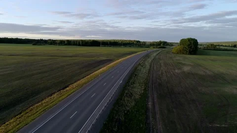 Aerial view of an intercity road between green fields in the beautiful morning Stock-Footage 168662965
