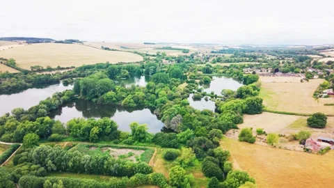 Aerial View of Interconnected Lakes Near English Village Видео 344012610