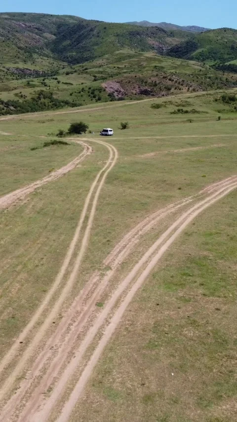 Aerial view of intersecting offroad tracks and tourist campsite in Kazakhstan Видео 338128787