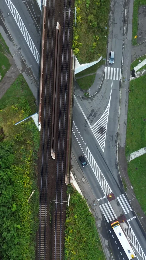 Aerial view of intersecting train tracks and roadways in an urban area Stock Footage 281404885