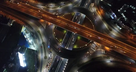 Aerial view intersection city transport circular road at night Stock Footage 128337990