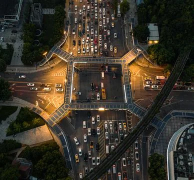 Aerial view of an intersection during the evening rush hour is filled with vehic Stock Photos