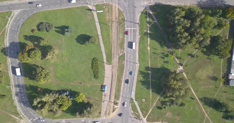 Aerial view of intersection, tram tracks and urban park Stock Footage 345370543