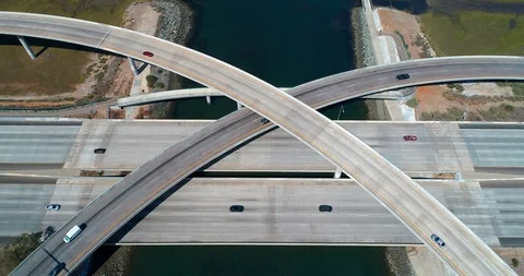 Aerial view of an interstate freeway intersection junction on sunny day Stock Footage 111605958