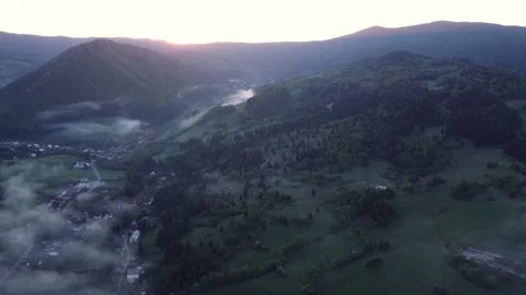 Aerial view, inversion in a valley with forests, meadows at sunrise. Houses Stock-Footage 197067116