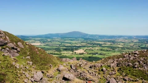 Aerial View of Irish Farmland with Patchwork Fields and Forests Under Clear Stock Footage 315770494