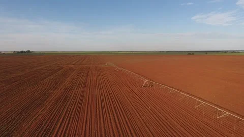 Aerial View of Irrigation Pivot on Red Planted Crop Field Stock Footage 243567037