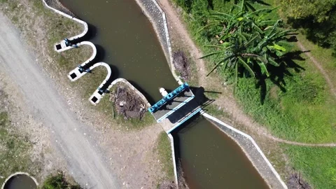 Aerial view of irrigation river flow, water inlet to flow water in agricult.. Stock Footage 315663661