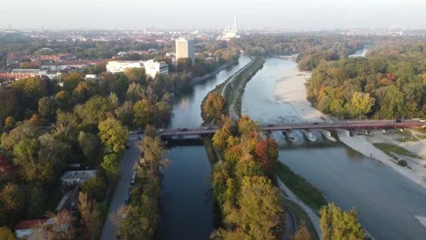 Aerial view of Isar river flowing into Munich and Thalkirchen bridge Stock Footage
