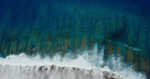 Aerial view of island reef with breaking waves Stock Footage 115063253