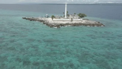 Aerial View of an islet with a lighthouse 2 Stock Footage 246624988