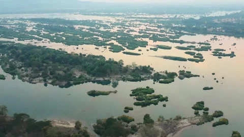 Aerial view of islets of Don Det, Laos. Dynamic drone shot of village at sunset Stock Footage 248215040
