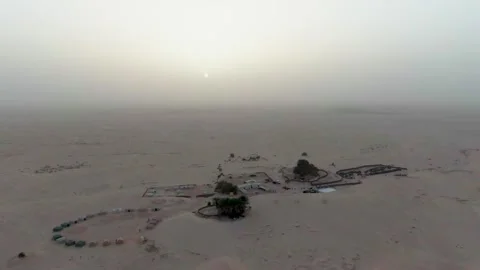 Aerial View Of Isolated Desert Camp At Sunrise Surrounded By Vast Empty Sand Stock Footage 328387108