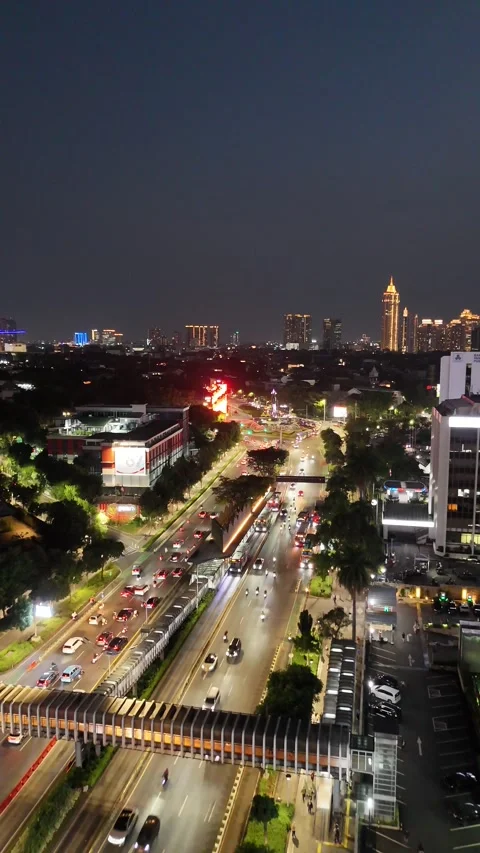 Aerial View of Jakarta Night Cityscape with Illuminated Skyscrapers and Traffic Stock Footage 341080098