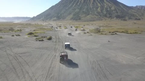 Aerial View of Jeep down the Bromo Sand Sea Stock Footage 205835894
