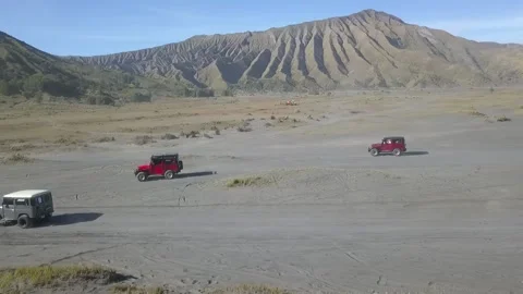Aerial View of Jeep down the Bromo Sand Sea Stock Footage 205838630