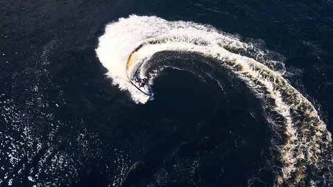 Aerial view of Jet Ski Doing Spins at Dusk Stock Footage 128002938