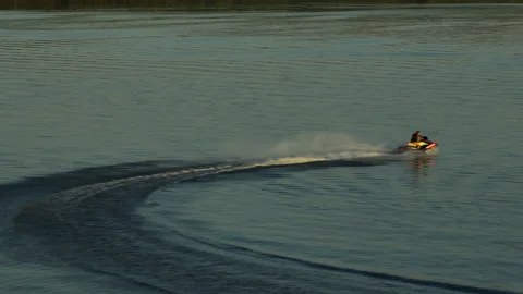 Aerial view. The jet ski makes a sharp turn on the water of the river.  Stock-Footage 218627323