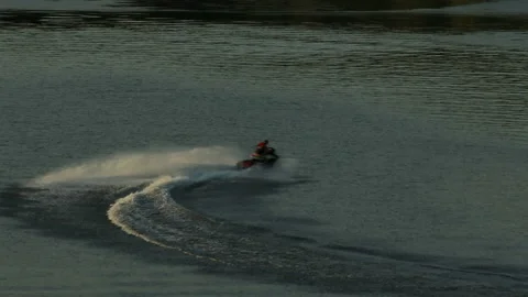 Aerial view. The jet ski makes a sharp turn on the water of the river. Stock Footage 218629018