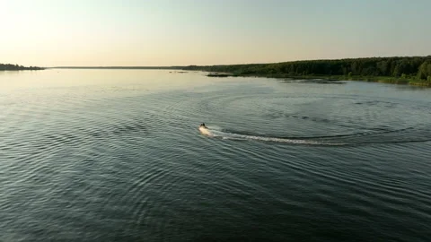 Aerial view. The jet ski makes a sharp turns on the water of the river.  스톡 동영상 218630624