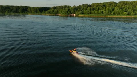Aerial view. The jet ski makes a sharp turn on the water of the river. Stock Footage 218631070