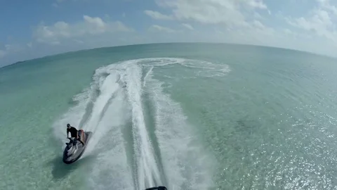 Aerial view of jet skies pulling up to the sand on Copperfield's Island, Musha 스톡 동영상 77744444
