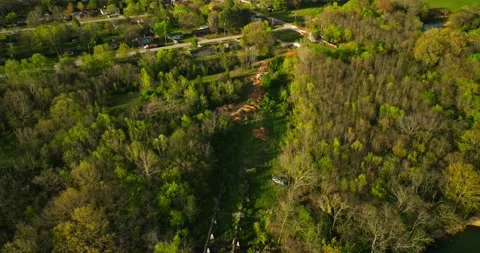 Aerial view of junk yard in with stacks of used cars in wooded area in Stockbeeldmateriaal 239036757