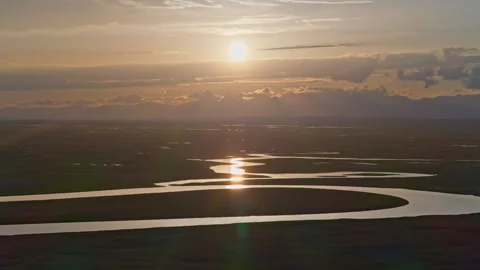 Aerial View of Kaidu River in Bayanbulak at Golden Sunset Stock Footage 343137062