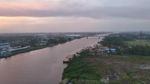 Aerial View of Kapuas River Industrial Waterfront and Cityscape at Dusk Video stock 347459953