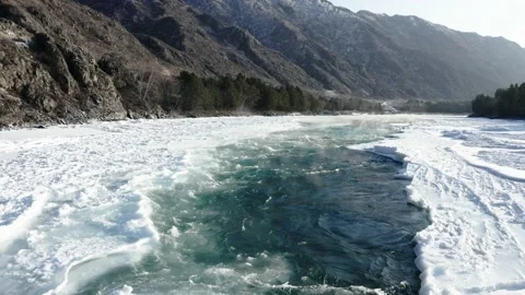 Aerial view of the Katun River in the ice Stockbeeldmateriaal 147880930