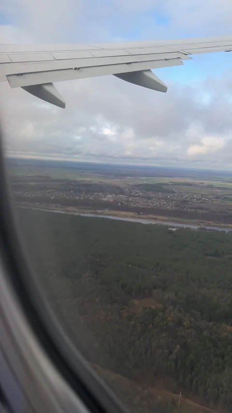 Aerial view of Kaunas from airplane window in November. Vertical video Stock Footage 294103147