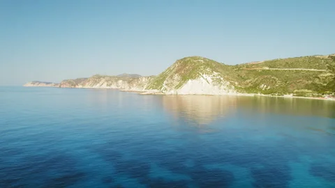 Aerial view of Kefalonia cliffs meeting the Ionian Sea on a clear summer day Stock Footage 345533271